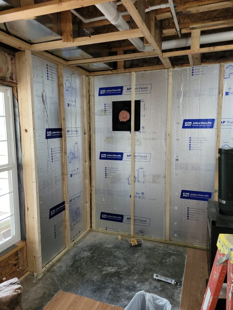 Basement corner framed and insulated for the wood stove