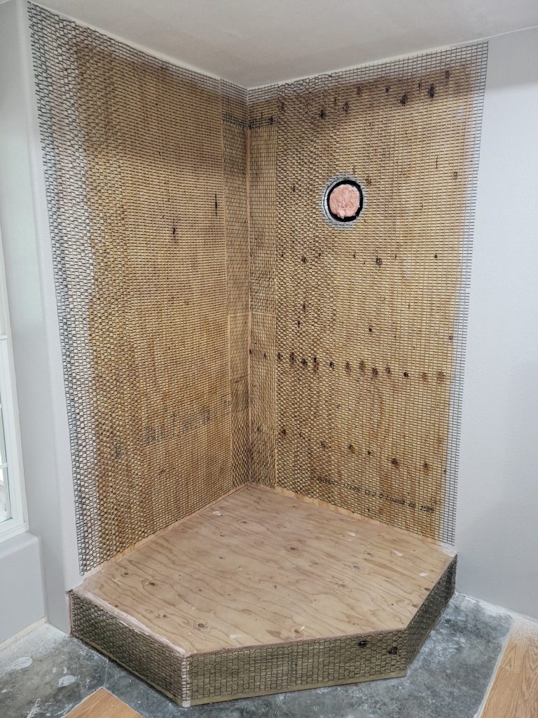 Fiberglass mesh stapled over plywood for the stone veneer wall