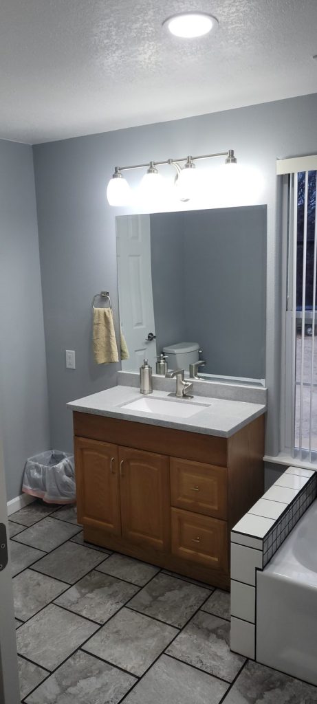 Finished Jack and Jill bathroom vanity with new mirror and LED light bar