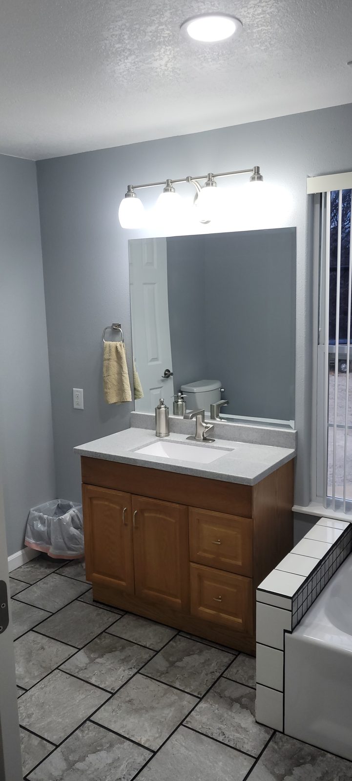 Finished Jack and Jill bathroom vanity with new mirror and LED light bar